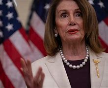 Image result for Pelosi Hands Out Pens with Her Name On Them