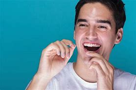 Image result for Flossing Teeth with Braces