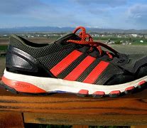 Image result for Black Adidas with Gold Stripes