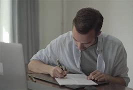 Image result for Guy Writing at a Desk