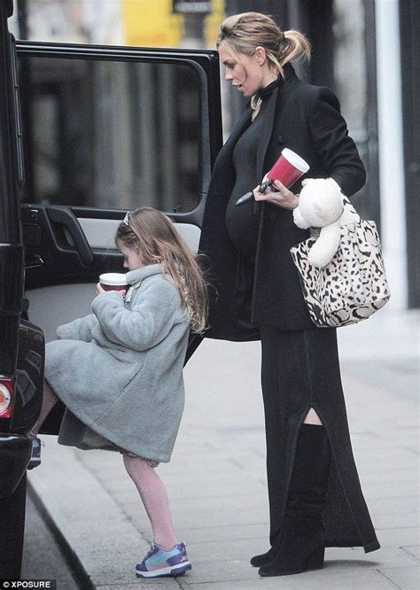 Abbey Clancy shows off baby bump as she steps out with daughter Sophia  