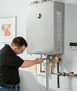 Image result for Rheem Gas Tankless Water Heater: Indoor, Natural Gas, 199,900 Btuh, 8.4 GPM @ 45F Rise Model: RTGH-C95DVLN