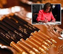 Image result for Pelosi Hands Out Gold Pens