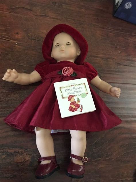 Bitty Baby with Holiday outfit and book Good used condition. Brown hair  