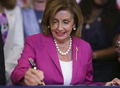 Image result for Nancy Pelosi in a African Hat