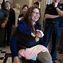Image result for Jacinda Ardern Voting in Parliament with Baby