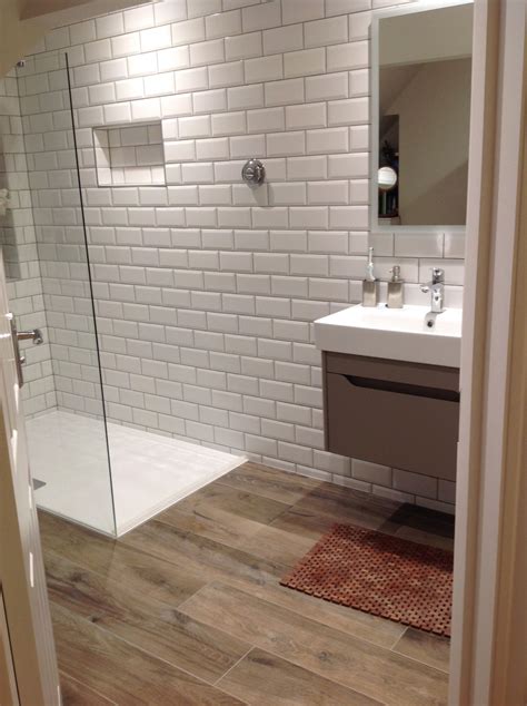Ensuite Shower room   White subway tiles with wood affect floor tiles  