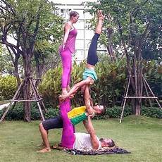 Bob and Trish acro yoga four person acro pose pillar of pink
