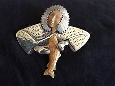 Zealandia Inuit with salmon brooch Sterling with fossil ivory