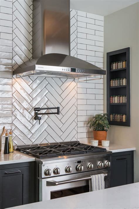 Modern Black and White Kitchen with White Herringbone Tile Backsplash  