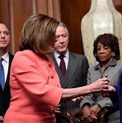 Image result for Pelosi Hands Articles of Impeachment Pen to Schiff