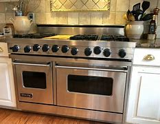 Image result for UM12FDNS3BUG 48" Majestic II Series Dual Fuel Natural Gas Range With 8 Burners And Griddle 5.02 Cu. Ft. Total Oven Capacity TFT Oven Control Display Brass Trim In