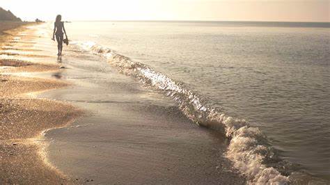 Woman walking on seashore, waves. Girl outdoors at sunrise. Stock Video ...