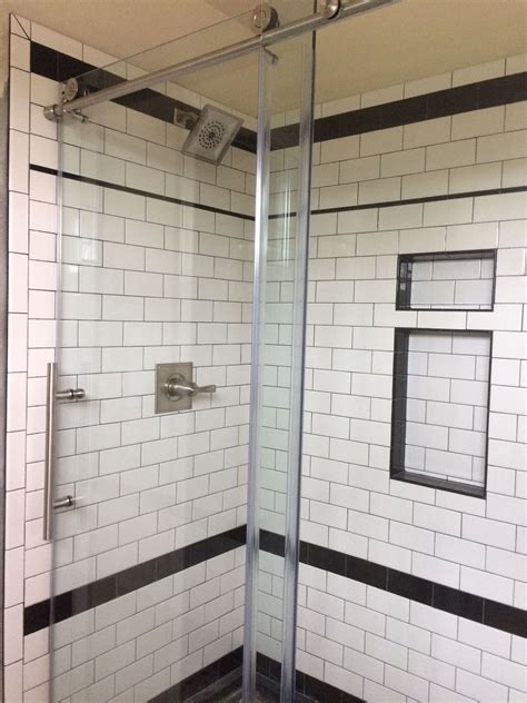 I am in love with my new shower! White subway tiles with black grout  
