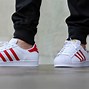 Image result for Adidas Superstar Black with Red Stripes