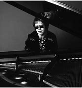 Image result for Picture of Elton John in His Suits