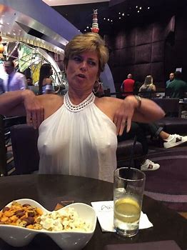 Milf displaying her boobs inside a restaurant in her transparen