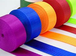  Colorful rolls of nylon webbing in purple, orange, red, and yellow, showing the variety of options for sewing projects.
