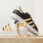 Image result for black and gold adidas shoes