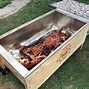 Image result for La Caja China Pig Cooker