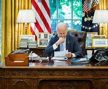 Image result for Joe Biden Sitting at a Desk