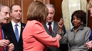 Image result for Pelosi Giggling Passing Out Gold Pens