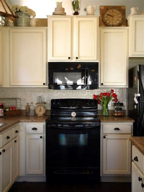 Off White cabinets with black appliances.   Black appliances kitchen  