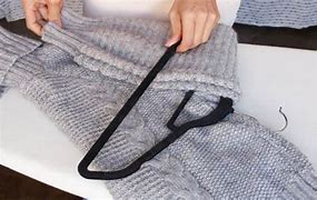 Image result for How to Fold Sweaters On Hangers