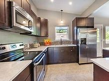Image result for Black Stainless Steel Appliances with Off White Kitchen Cabinets