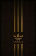 Image result for black adidas with gold logo