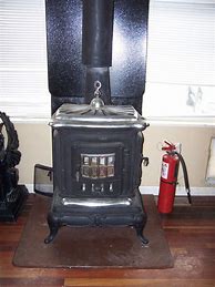 Image result for Vintage Cast Iron Parlor Wood Stove Pic