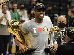 Image result for Giannis Antetokounmpo Milwaukee Bucks Autographed 16" X 20" 2021 NBA Finals Trophy Spotlight Photograph With "21 MVP" Inscription Size: No Size