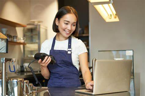 Smiling Asian Barista, Girl with Card Terminal, Payment Machine and Laptop, Standing in Cafe ...