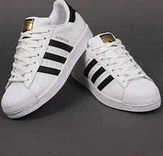 Image result for Black Adidas Shoes with Gold Stripes