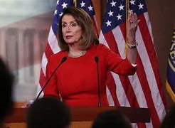 Image result for Nancy Pelosi at Podium with Flag