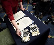 Image result for Pelosi Passing Out Pens