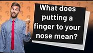 What does putting a finger to your nose mean?