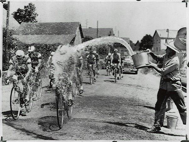"Roadside spectators help Tour de France cyclists fight the heat by ...