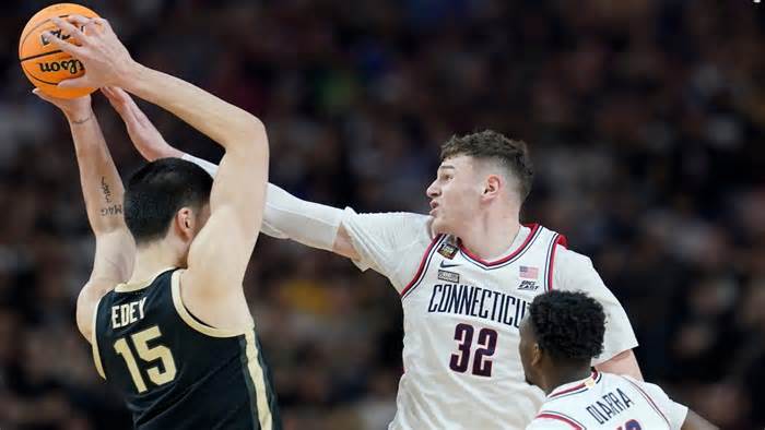 Purdue Boilermakers center Zach Edey (15) is defended by Connecticut Huskies center Donovan Clingan (32) and Connecticut Huskies guard Hassan Diarra (10) during the NCAA Men‚Äôs Basketball Tournament Championship, Monday, April 8, 2024, at State Farm Stadium in Glendale, Ariz.