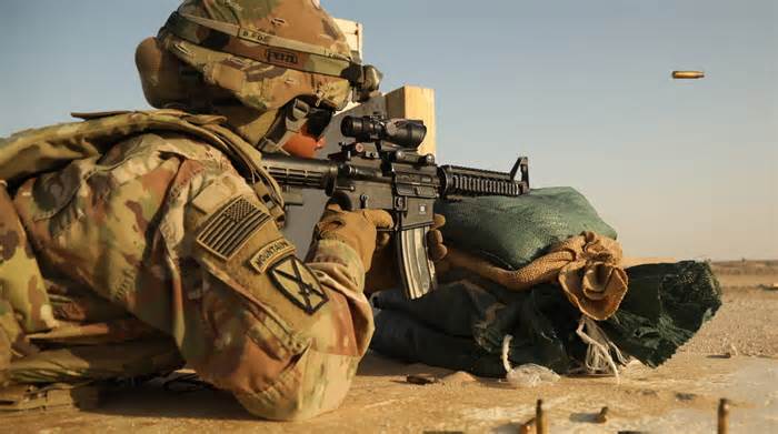 A soldier fires an M-4 in rifle qualification. The Marksmanship Master Trainer Course qualifies soldiers as marksmanship instructors for their home units. Army photo.