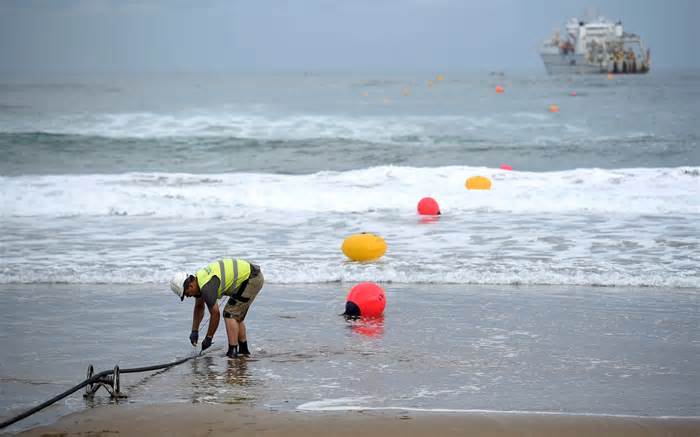 A telecoms worker carries out checks during the laying of a new undersea communications cable from the Spanish coast in 2017. Such cables are easy to access at the points where they come ashore