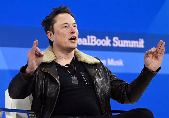 Elon Musk speaks on stage during The New York Times Dealbook Summit today in New York City.