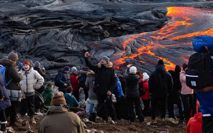 A man take a selfie in front of the lava field on March 28, 2021 on the Reykjanes Peninsula, Iceland.