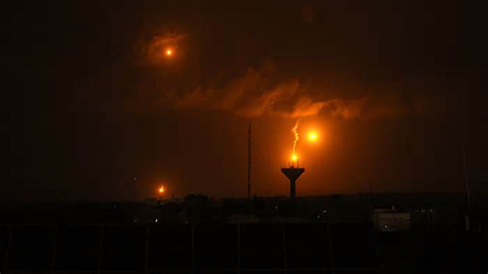 A picture taken from Rafah on January 23, 2024, shows flares fired by Israeli soldiers over Khan Yunis in the southern Gaza Strip during Israeli bombardment, amid continuing battles between Israel and the Palestinian militant group Hamas. The Israeli army said it had suffered its biggest single-day losses since the start of its ground war in Gaza amid growing pressure on the government to find a way to end the conflict.