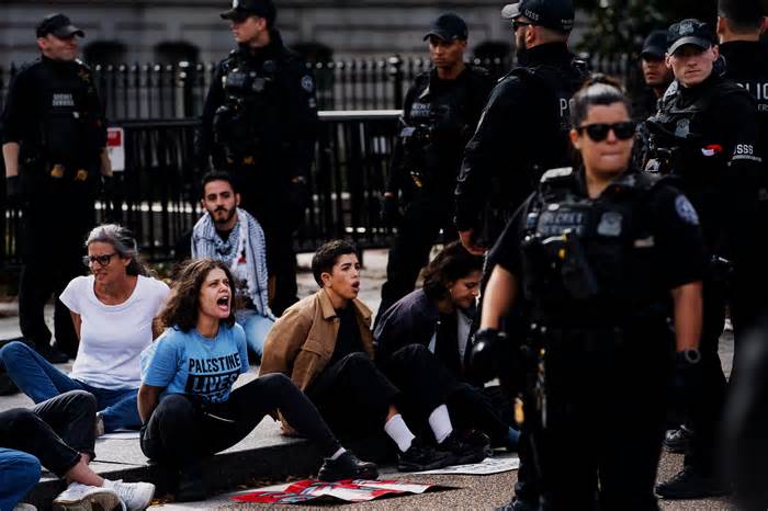 Demonstrators calling on President Biden to urge a cease-fire in the Israel-Gaza war are detained by U.S. Secret Service personnel outside the White House on Monday.