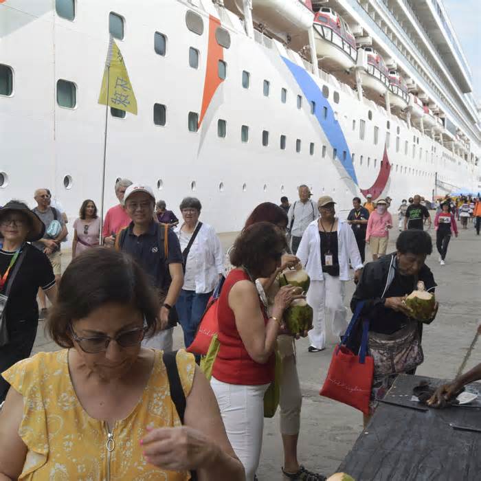 Some of the more than 2,000 tourists who were on board the MV Norwegian Dawn cruise ship are assisted to disembark soon after the ship docked at the port of Mombasa, Kenya, from Seychelles, Jan. 14, 2024.