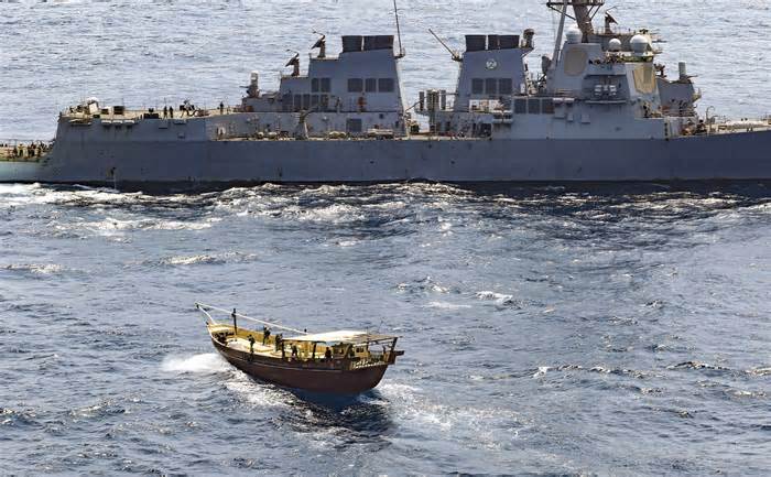 In this handout photo from the U.S. Navy, the USS Winston S. Churchill interdicts a stateless dhow off the coast of Somalia in February 2021.