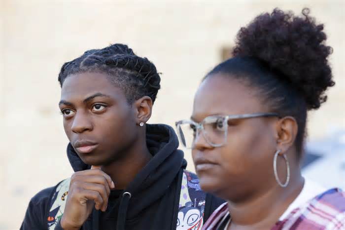 Darryl George, left, a 17-year-old junior, and mother Darresha George, right, talk with reporters in September before Darryl served a 5-day in-school suspension at Barbers Hill High School in Mont Belvieu, Texas.