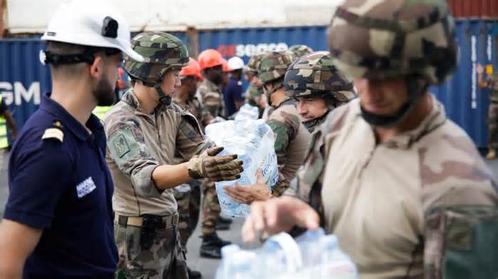 Soldiers unload water packs following the arrival of a ship on the French island of Mayotte carrying 600,000 liters of bottled water for distribution to the department's most vulnerable people, on September 20, 2023. - Chafion Madi/AFP/Getty Images