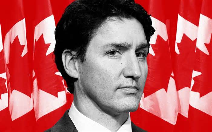 Justin Trudeau in front of Canadian flags red background